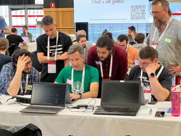 Mike Anello (mentor) and team members working on a core issue during Drupalcon Lille 2023.
